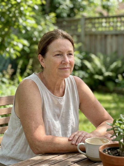 Mature woman learning about daily skin care